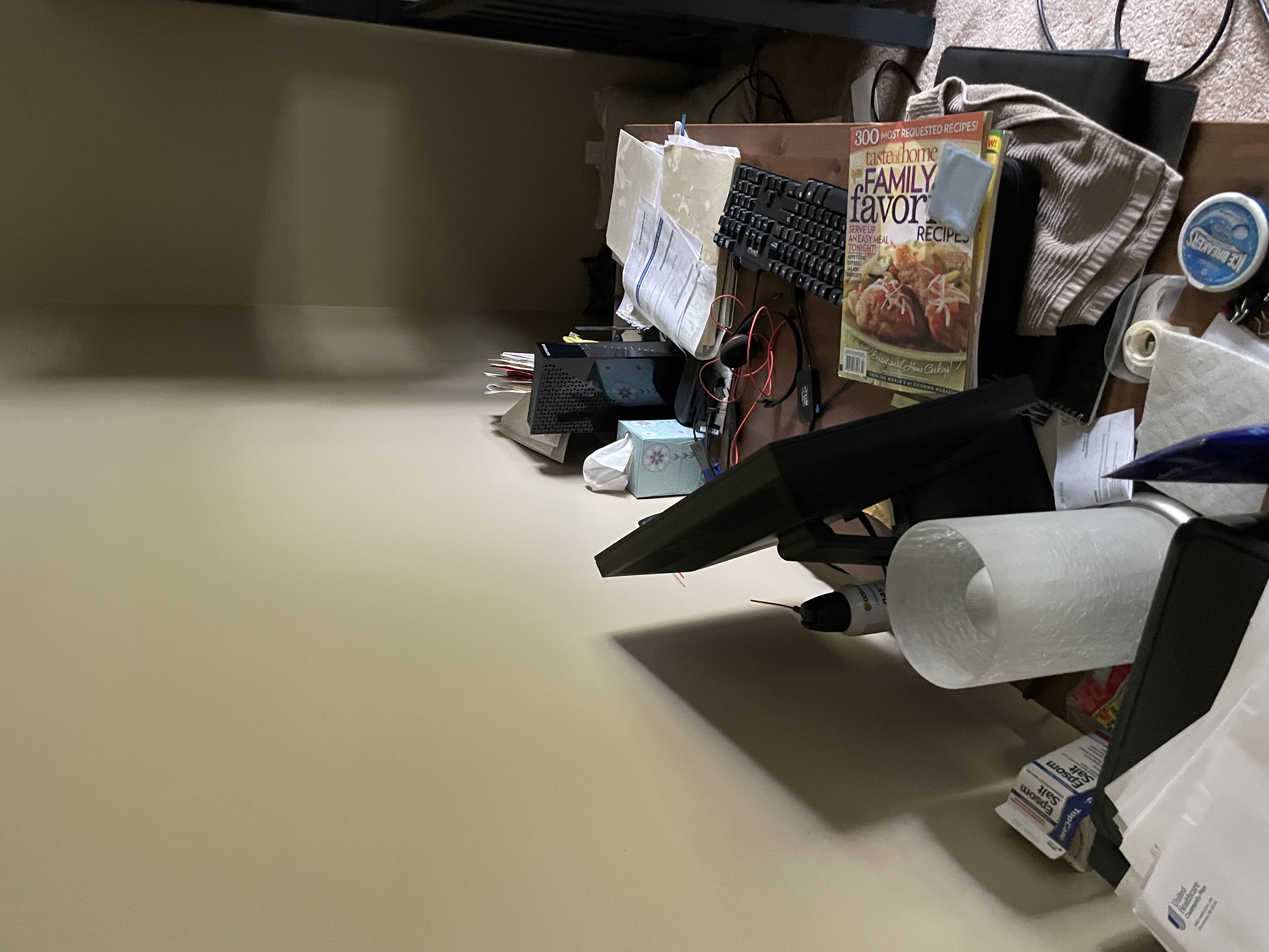 Office workspace affected by water damage with personal items, papers, and office equipment scattered requiring contents pack-out and protection services