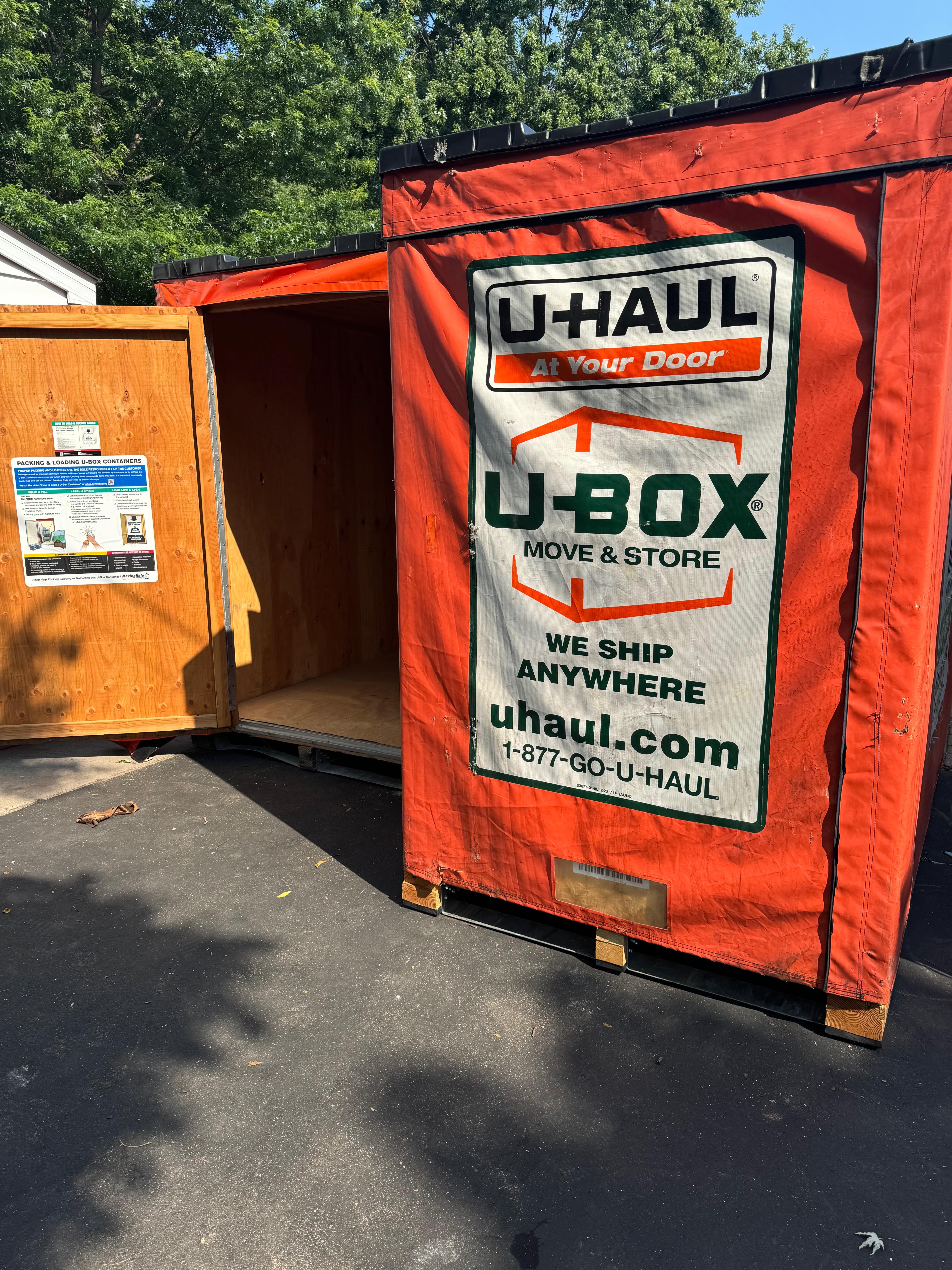U-Haul U-Box moving and storage containers with orange tarps used for contents storage during water damage restoration work